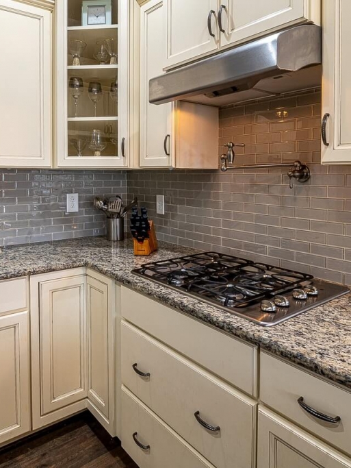 stainless-steel-faucet-beside-white-wooden-kitchen-cabinet-3958950