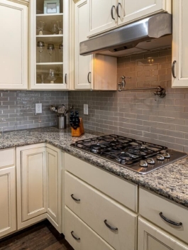 stainless-steel-faucet-beside-white-wooden-kitchen-cabinet-3958950