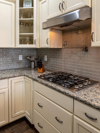 stainless-steel-faucet-beside-white-wooden-kitchen-cabinet-3958950