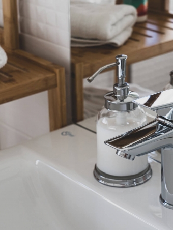 stainless-steel-faucet-on-white-ceramic-sink-3761560